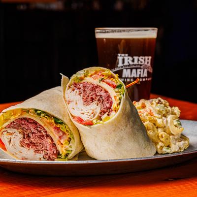 Corned beef and turkey wrap served with mac and cheese and beer.