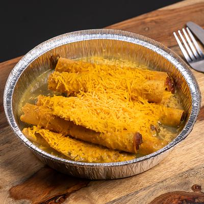 Rolled Tacos in green sauce, topped with grated cheese.