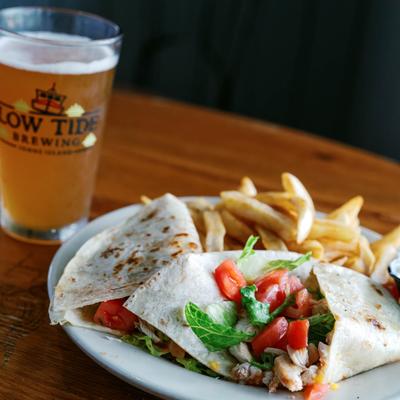 Fish Tacos, with lettuce, tomato, shredded cheese, sour cream, salsa, and fries.