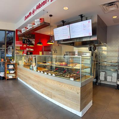 Counter with a glass display case and wooden paneling.