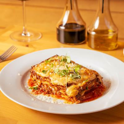Lasagna Bolognese served on a white plate.