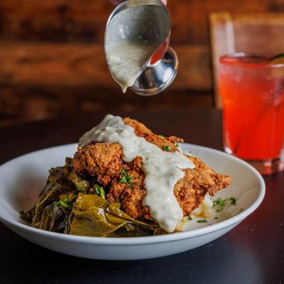 Fried chicken, with gravy and collard greens.