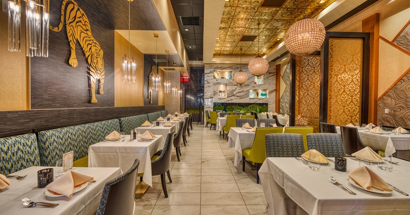 Spacious and cozy interior dining area with dining tables set for guests
