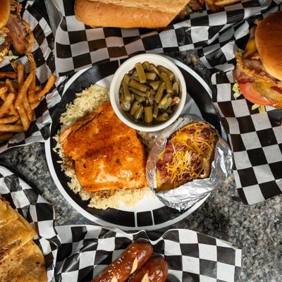 Glazed chicken served with rice, potato, and green beans.