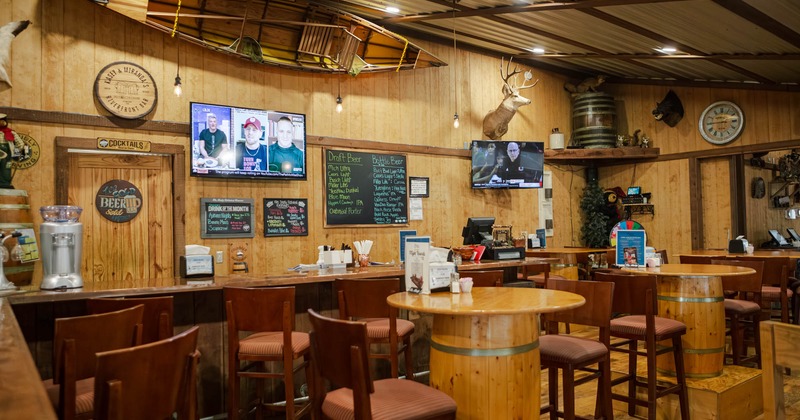 Interior, seating area with a bar in the back and wall decorations