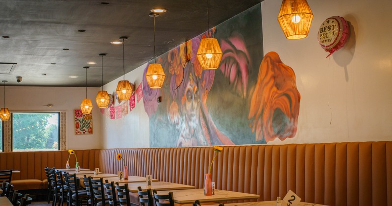 Interior, dining area, banquette seating, colorful Day of the Dead mural