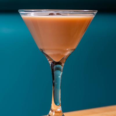 Light brown espresso martini cocktail in a martini glass.