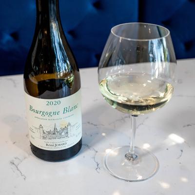 A bottle and glass of white wine.