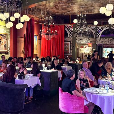 The restaurant full of people having dinner.