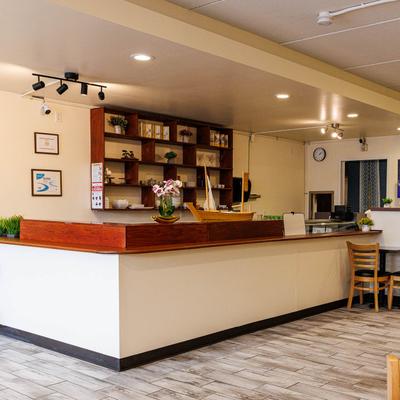 A modern wooden service counter with custom shelving inside a Korean restaurant.
