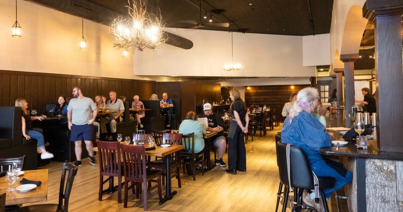 People dining at tables in a restaurant dining room