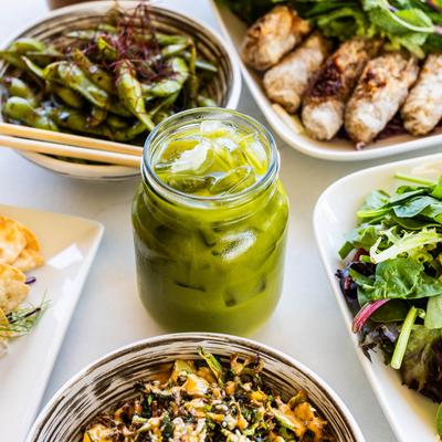Green Matcha Thai Tea jar sitting among various dishes on the table