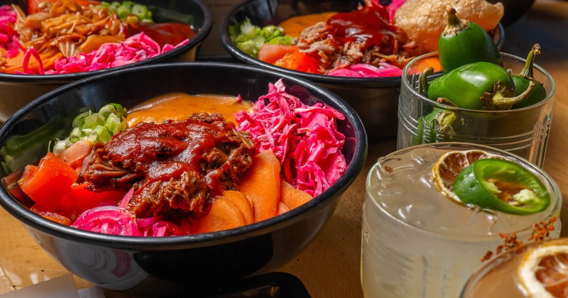 Assorted BBQ bowls with cocktails on a table