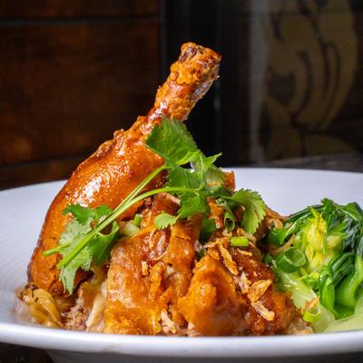 Crispy duck with steamed egg noodles and bok choy.