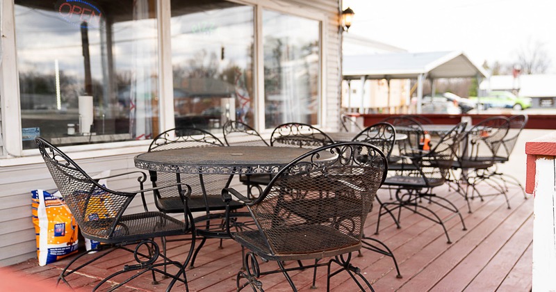 Exterior, patio, covered seating area, tables with chairs, wooden decking