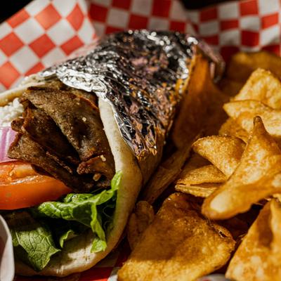 Gyro, with tomato, red onion, feta, lettuce and tzatziki, with a side of potato chips