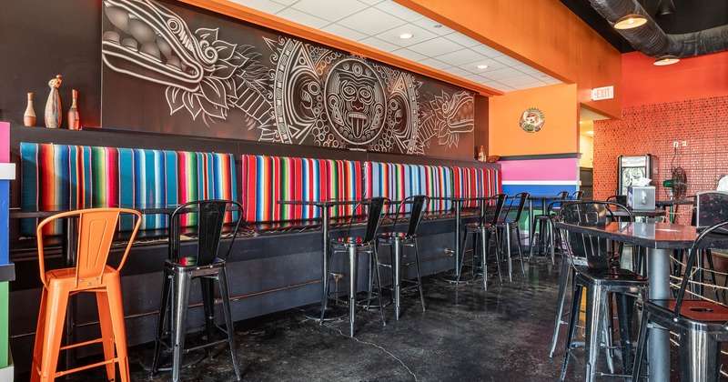 Interior, long seating bench, high tables and chairs