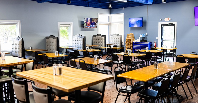 Interior, dining area, tables for four and eight, seating booths in the back, tile flooring