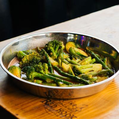 Sauteed mixed green vegetables in a metal pan.
