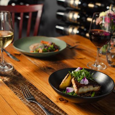 Grilled salmon fillet, with potatoes, herbs, and red and white wine.