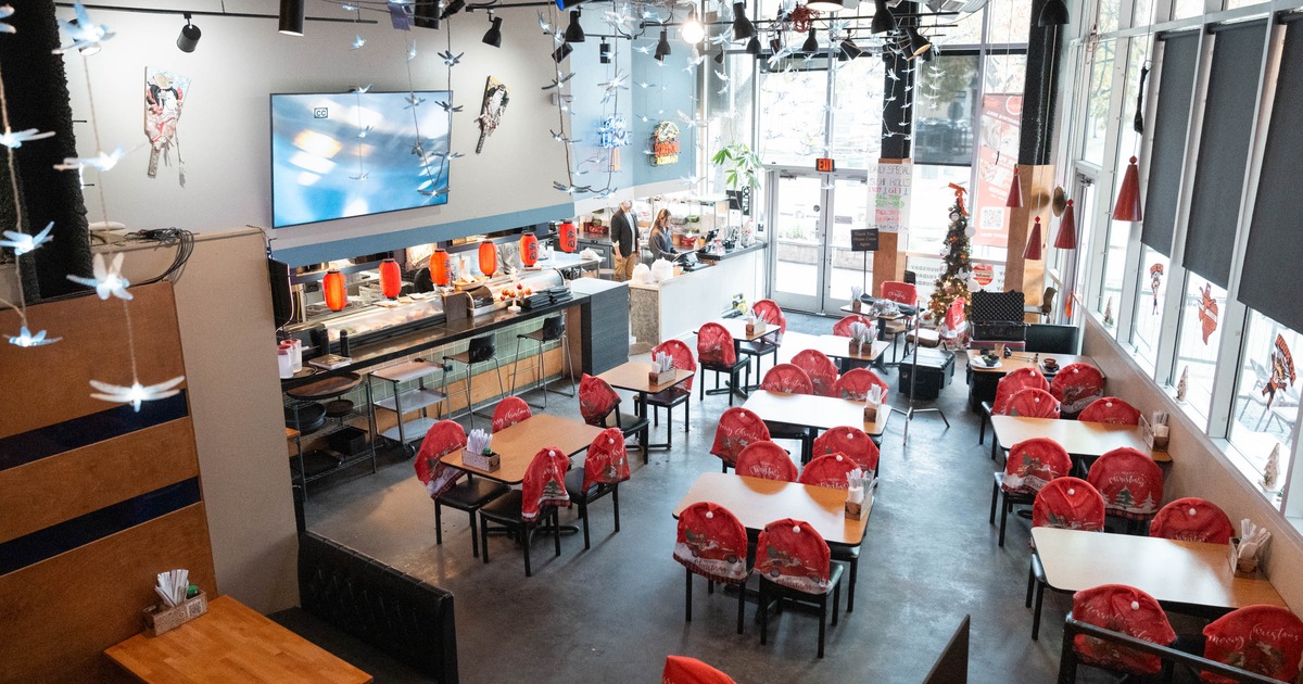 Interior, Christmas decoration, tables, red chair covers, a sushi bar, and a Christmas tree