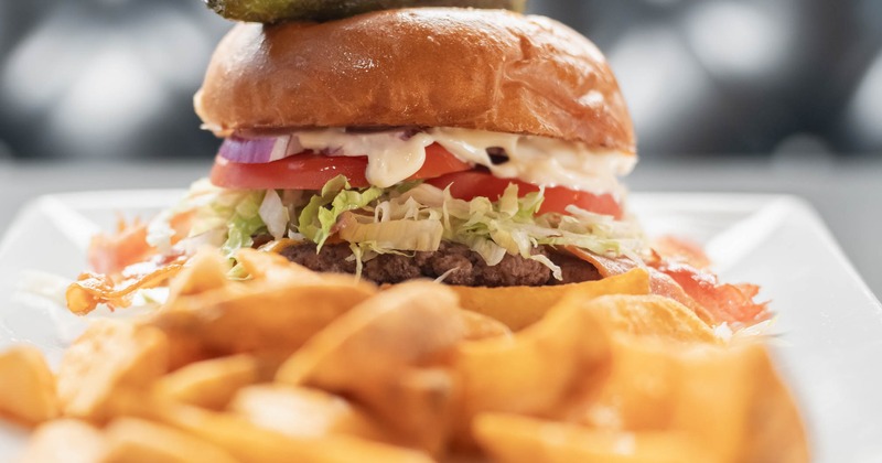 Jalapeno burger served with potato wedges
