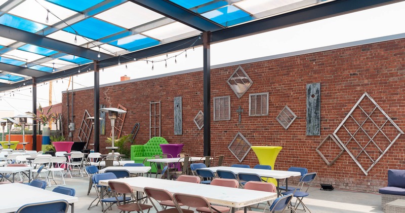 Exterior, covered seating area with tables and chairs