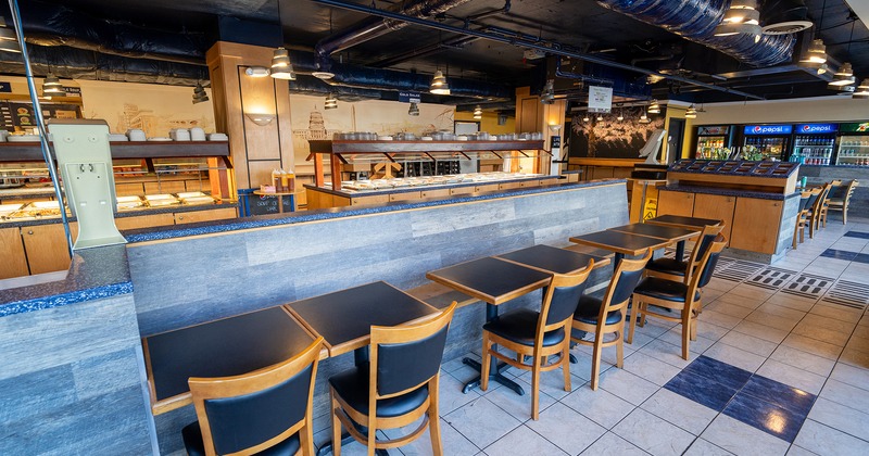 Interior space, seating area, buffet tables with various foods
