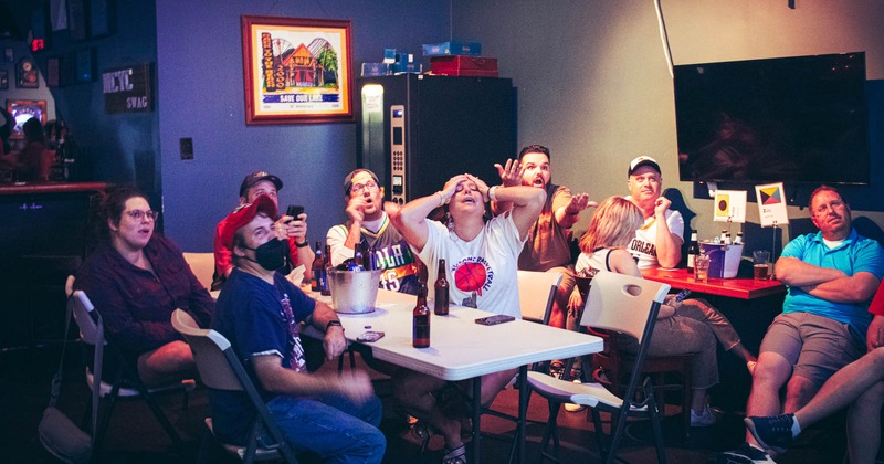 Customers watching a game