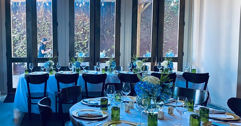 Interior, wedding setup, lavishly decorated tables for twelve and eight