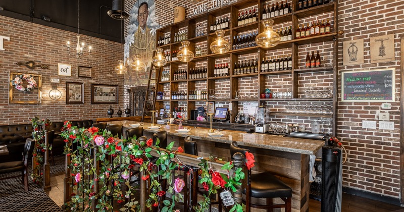 Bar with bar stools, drink rack behind