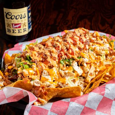 Fried chicken nachos, with bacon, ranch, lettuce, and salsa.