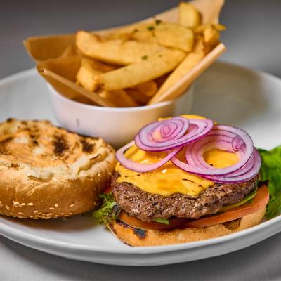 Cheeseburger with lettuce, tomato, and onion, served with truffle fries.