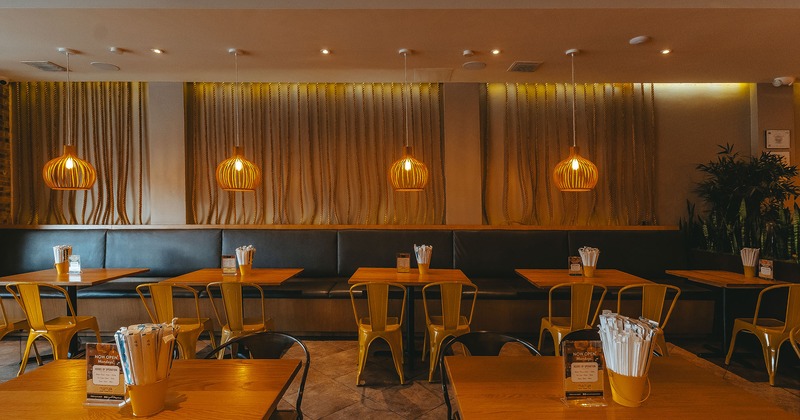 Restaurant interior, seating area with lined-up tables