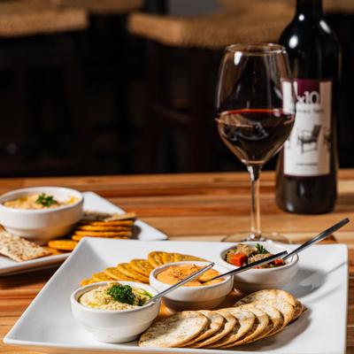 Trio of dips plat and glass of wine