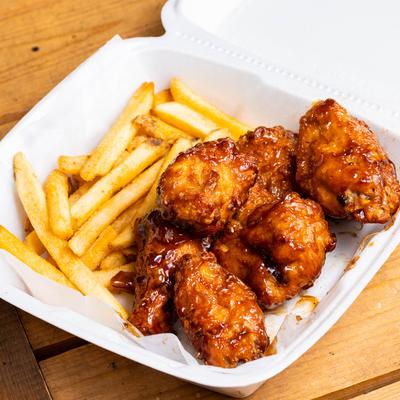 Teriyaki chicken wings and fries.
