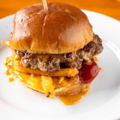 Cheeseburger with fries, ketchup, and melted cheese.