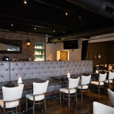 Interior,  restaurant scene showcasing tables and seating.