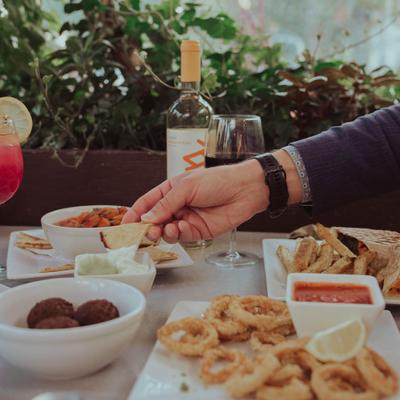 Guest serving themself to food on the table.