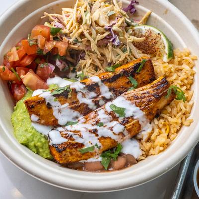 Mahi mahi bowl with rice, plantains, slaw, and avocado.
