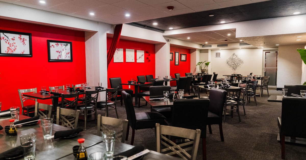 Inside, dining area with red walls and pictures