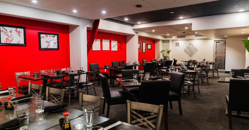 Inside, dining area with red walls and pictures