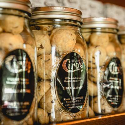 Glass jars filled with cookies on a shelf.