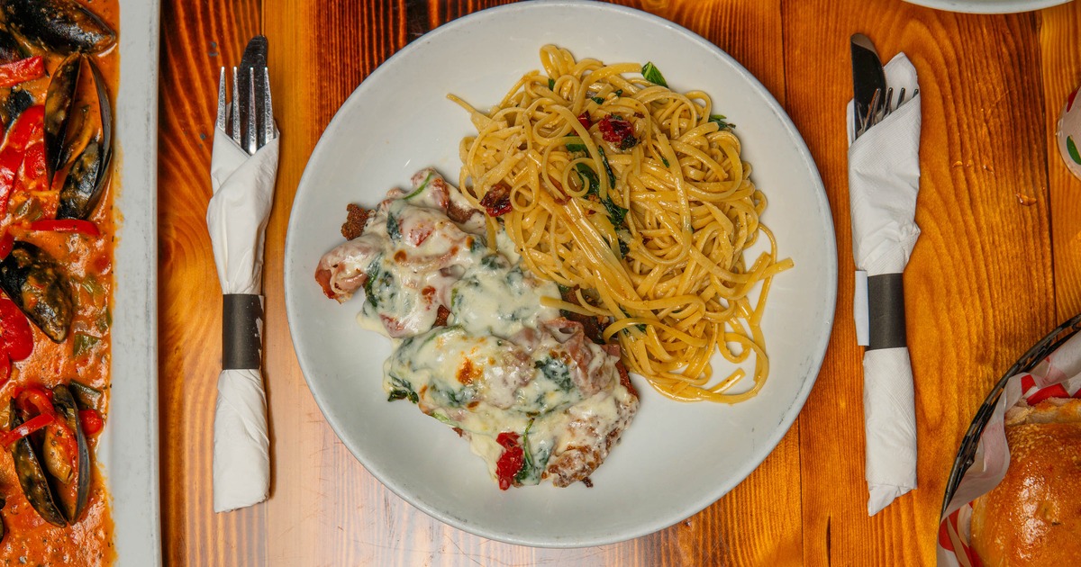 Breaded chicken cutlet smothered in cheese and peppers, with linguine on the side