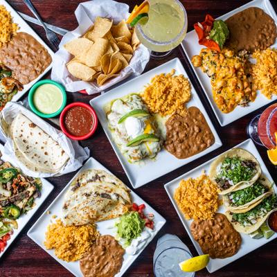 Variety of dishes and drinks served on the table, overhead view.