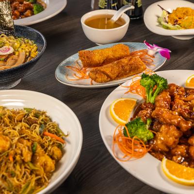 Assortment of food dishes on a dark wooden table.