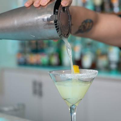 Bartender pouring a cocktail.