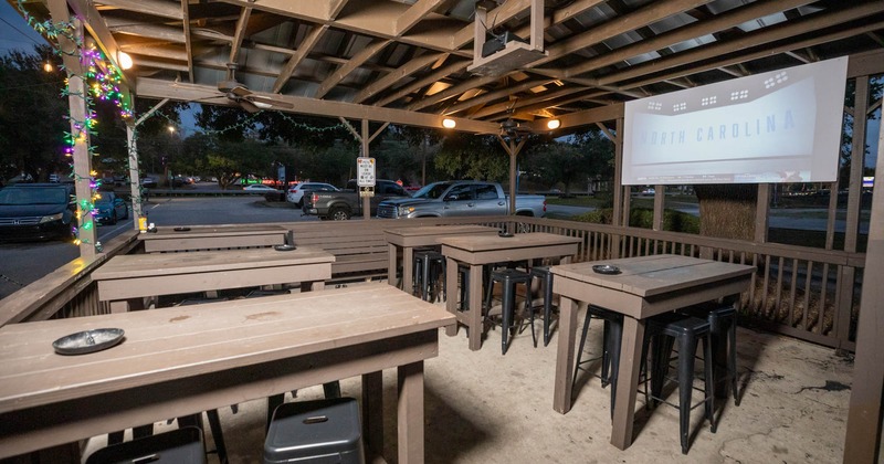 Exterior, patio, covered seating area, high seating wooden tables with stools