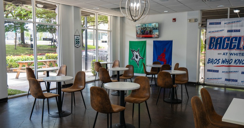 Interior, seating area, round tables for two and four, large shop window, tile flooring