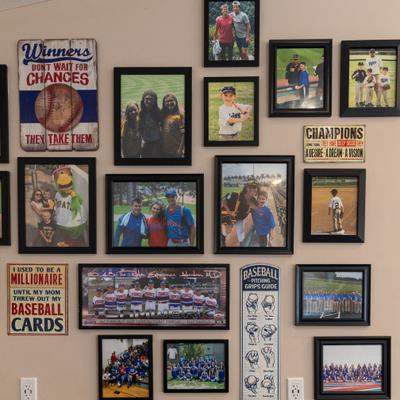 Wall display of framed baseball photos and signs.